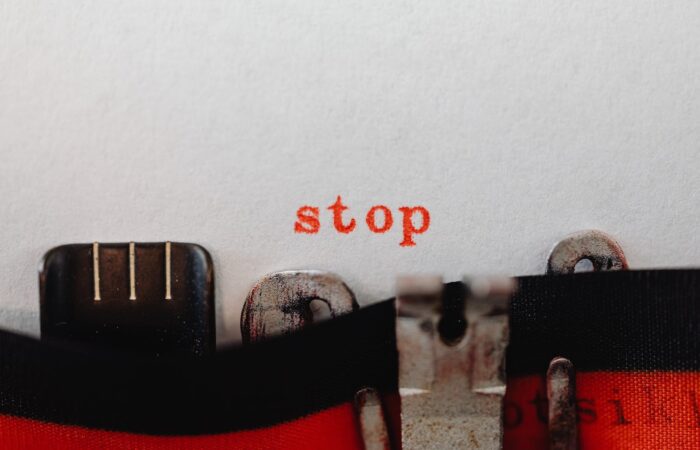 Red Stop Word Coming out of a Typewriter